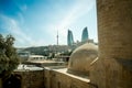 Gobbez of an old mosque in Baku Old city with the new city background. Royalty Free Stock Photo