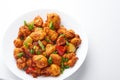 Gobi Manchurian in bowl at black concrete background. Indian Chinese cuisine dish with deep-fried cauliflower Royalty Free Stock Photo