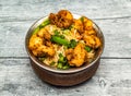 gobi noodle or fried cauliflower noodles served in copper dish isolated on wooden table top view of indian spicy food Royalty Free Stock Photo