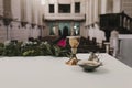Goblet of wine on table during a wedding ceremony nuptial mass. Religion concept. Catholic eucharist ornaments for the celebration