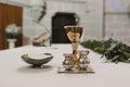 Goblet of wine on table during a wedding ceremony nuptial mass. Religion concept. Catholic eucharist ornaments for the celebration