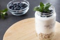 goblet of yogurt with cereals and fruits strewed on leaves mint Royalty Free Stock Photo