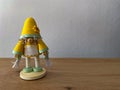 Goblin, elf, dwarf woman or girl or wife, in yellow, cute paper statue