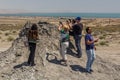 GOBUSTAN, AZERBAIJAN - JUNE 19, 2018: Tourists observe a mud volcano in Gobustan Qobustan , Azerbaij