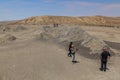 GOBUSTAN, AZERBAIJAN - JUNE 19, 2018: Tourists observe a mud volcano in Gobustan Qobustan , Azerbaij