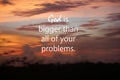 God is bigger than all of your problems. Spiritual inspirational words concept with text message on blurry sunset sky.