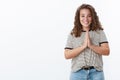 God hear us. Charming hopeful happy relieved young chubby curly-haired girl blue eyes cupped hands together pray gesture
