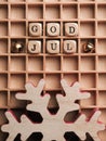 God Jul on small wooden blocks with a red wooden snow flake Royalty Free Stock Photo