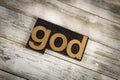 God Letterpress Word on Wooden Background