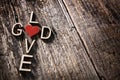 God and love words written in the shape of a religious cross with red heart background Royalty Free Stock Photo