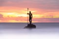 God Neptune among smooth waters at Melenara Beach Spain at sunrise Royalty Free Stock Photo