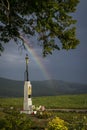 God`s torture under a tree on a hill and a rainbow Royalty Free Stock Photo