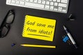 God save me from idiots - message on office workplace. Watch out for stupid people Royalty Free Stock Photo