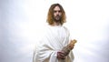 God in white robe holding wine bottle, Eucharist in Catholic church, Communion Royalty Free Stock Photo