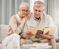 God, worship and senior couple with bible on a sofa relax with scripture, study or reading in their home. Holy, book and Royalty Free Stock Photo