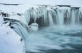 Godafoss Waterfall in Iceland, partially frozen in winter. Long exposure motion blur Royalty Free Stock Photo