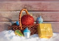 Goden christmas gift box and christmas decorations in wicker basket