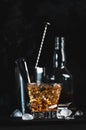 Godfather alcoholic cocktail with scotch whiskey, amaretto liqueur and ice. Black bar counter background, steel bar tools, copy Royalty Free Stock Photo