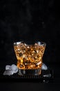 Godfather alcoholic cocktail with scotch whiskey, amaretto liqueur and ice. Black bar counter background, steel bar tools, copy Royalty Free Stock Photo