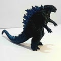 Godzila toy with angry face with shadow and white background