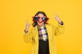 She goes crazy. Crazy child show horns sign hand gesture. Happy girl with crazy look yellow background. Fashion kid wear