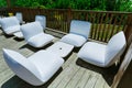 Gogeous relaxing inviting view of luxury outdoor backyard furniture, comfortable white beautiful cozy chairs Royalty Free Stock Photo