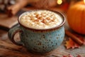 Gogol-Mogol in ceramic cup, with rich frothy texture and sprinkle of cinnamon on top, set on rustic wooden table. Egg