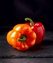 Gogosari peppers, a sweet Romanian ribbed heirloom Capsicum annuum fruit. Whole ripe pods. Bell peppers on a black background