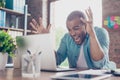 Going crazy at work. Young mulatto entrepreneur is shocked of the fail he has in business, he is yelling and gesturing like crazy Royalty Free Stock Photo