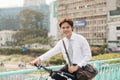 Going everywhere by his bike. Side view of young businessman loo Royalty Free Stock Photo