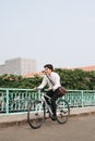 Going everywhere by his bike. Side view of young businessman loo Royalty Free Stock Photo