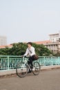 Going everywhere by his bike. Side view of young businessman looking forward while riding on his bicycle Royalty Free Stock Photo