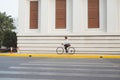 Going everywhere by his bike. Side view of young businessman looking forward while riding on his bicycle Royalty Free Stock Photo