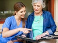 Going through the family album. a resident and a nurse looking through a photo album. Royalty Free Stock Photo