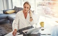 Going through her paperwork to finalise everything. a mature businesswoman working from her home office. Royalty Free Stock Photo