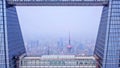 Going into hole of building to Pearl Tower. Aerial view of Shanghai Downtown, China. Financial district and business centers in