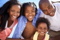 Going in for a huddle. Low view portrait of a happy african-american family spending the day at the beach together. Royalty Free Stock Photo