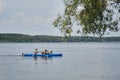 Going kayak boating with dogs on river, active pets concept, happy dog and owner on adventure. Young couple with dreadlocks having