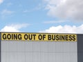 Going out of business writing in black on yellow letters on a white cladded industrial building