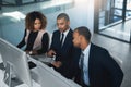 Going over the paperwork together. High angle shot of three corporate businesspeople looking over some paperwork in Royalty Free Stock Photo