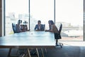 Going over their plan of action in the boardroom. Full length shot of a group of businesspeople meeting in the boardroom Royalty Free Stock Photo