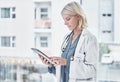 Going the paperless route of in patient care. a mature doctor using a digital tablet at work. Royalty Free Stock Photo