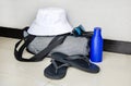 beach bag with towels, hat, sun lotion, sunglasses, flip flops are on floor in hotel room Royalty Free Stock Photo