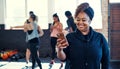 Going to take a before and after training photo. a cheerful young woman standing and using her cellphone before a