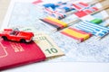 Going to travel. Passport, magnifier, red toy car and money on map. Save money on travel, planning for budget concept Royalty Free Stock Photo