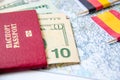 Going to travel. Passport, magnifier, red toy car and money on map. Save money on travel, planning for budget concept Royalty Free Stock Photo