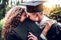 We are going together in adulthood. A loving couple of graduates are kissing