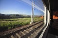 Going by train and watching landscape from the window.