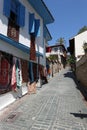 Going up back empty street with handmade craft carpet shop in the tourist area in Antalya old city