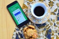 gojek apps on smartphone, with coffe and cake foto concept Royalty Free Stock Photo